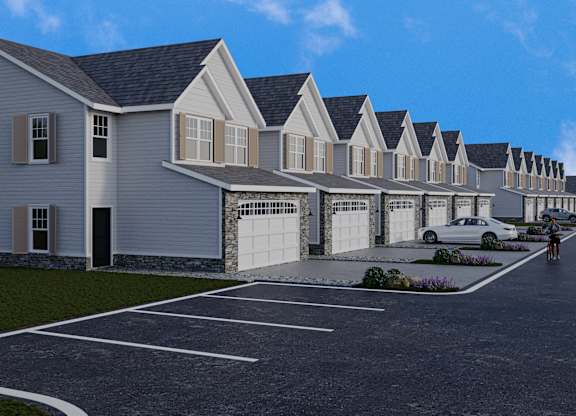 A row of houses with a person riding a bike in front.