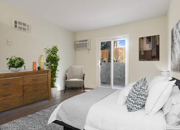 Bedroom with woos style floors, Air Conditioning, patio with sliding glass door