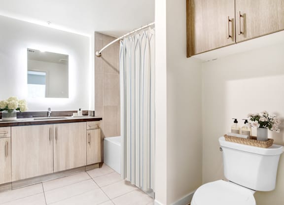 A modern bathroom with a white toilet and a white sink.at Vues on Gordon, Los Angeles California 