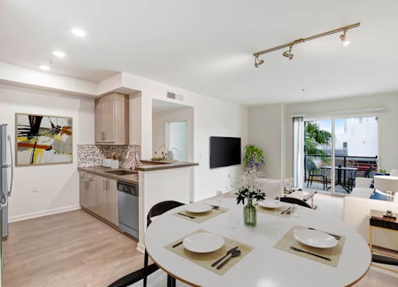 A modern kitchen with a dining table set for two.at Vues on Gordon, Los Angeles, CA 90028 
