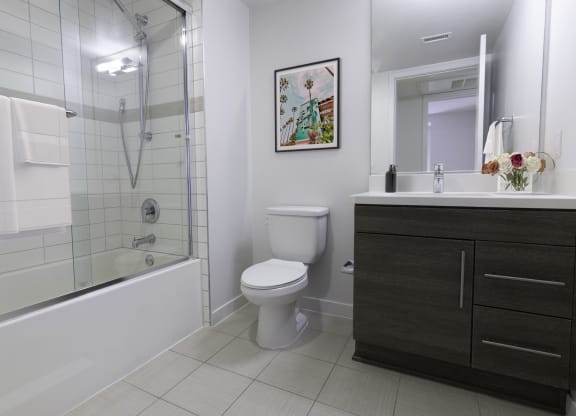 a bathroom with a shower and a toilet and a sink at Seventh West Apartments, Santa Monica California 