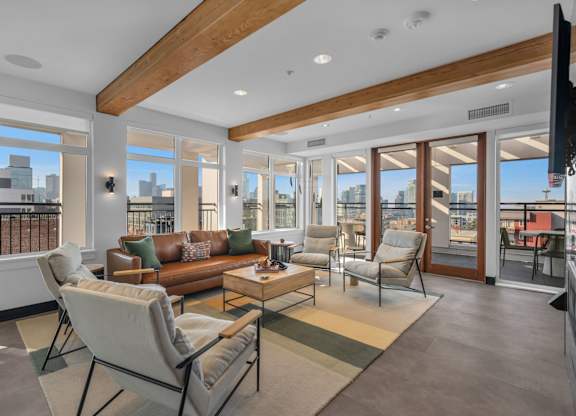 Bright living room with exposed wood beams at The Lyric Apartments, Washington, 98102
