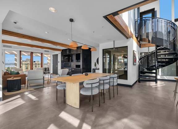 Open concept dining area with spiral staircase at The Lyric Apartments, Seattle, WA