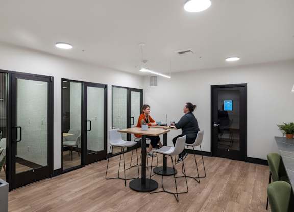 Private office pods with glass partitions at The Lyric Apartments, Washington, 98102