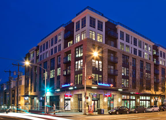 Modern mixed use building exterior at twilight at The Lyric Apartments, Seattle, WA 98102