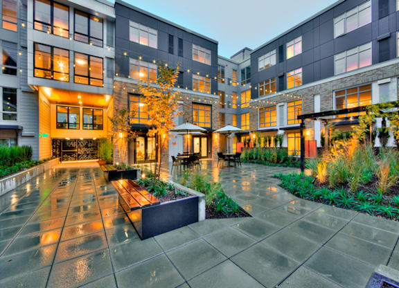 Interior courtyard with seating and landscape lighting at The Lyric Apartments, Seattle, WA