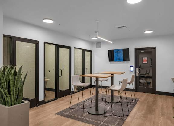 Collaborative workspace with high top table and phone booths at The Lyric Apartments, Seattle, 98102