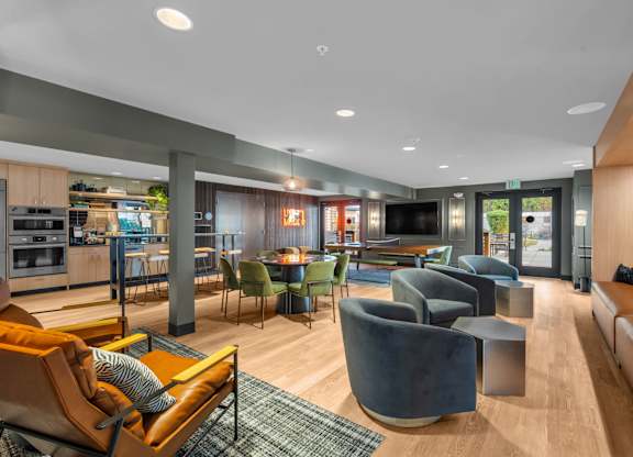 Open concept clubroom with kitchen and lounge seating at The Lyric Apartments, Seattle