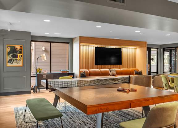Game room with ping pong table and lounge seating at The Lyric Apartments, Washington, 98102
