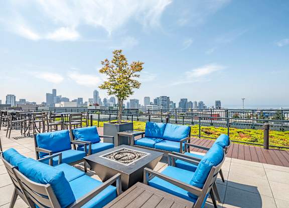 Rooftop lounge with fire pit and city skyline views at The Lyric Apartments, Seattle, Washington