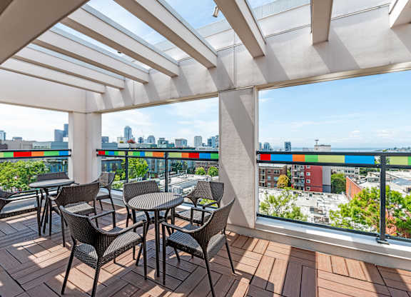 Covered rooftop terrace with colorful glass panels at The Lyric Apartments, Seattle, 98102