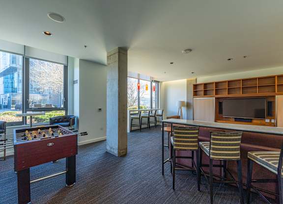 a living room with a bar and a foosball table