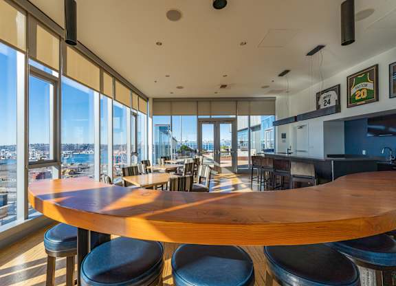 a dining room with a large wooden table and a view of the city