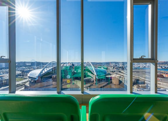 a view of a roller coaster from inside a bus with windows