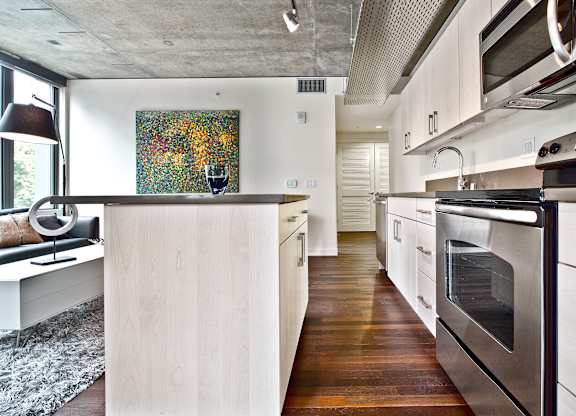 a kitchen with white cabinets and stainless steel appliances