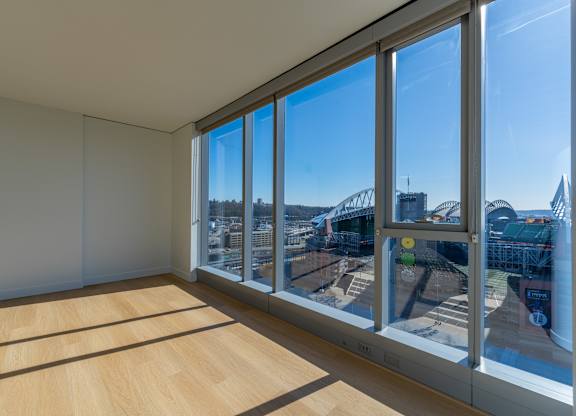a living room with large windows and a view of a city