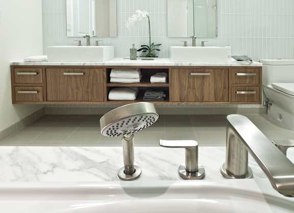 a bathroom with a shower and a sink and a toilet
