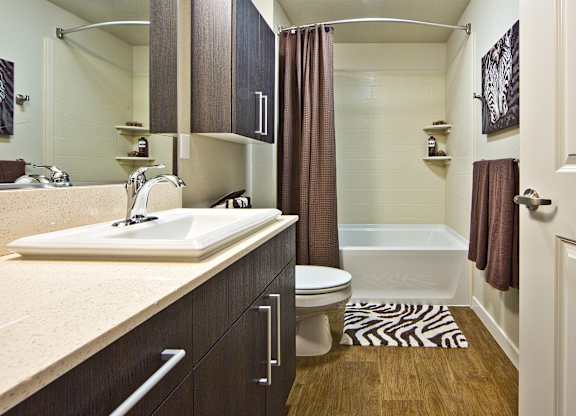 Bathroom with dual vanity and wood cabinetry at The Lyric Apartments, Washington, 98102
