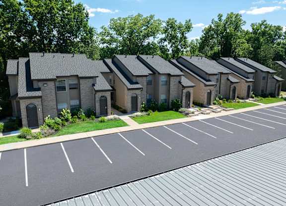 A parking lot in front of a row of houses.