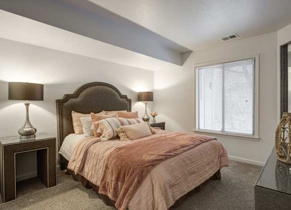 Bedroom with Nightstand at Hidden Lakes Apartments, Michigan