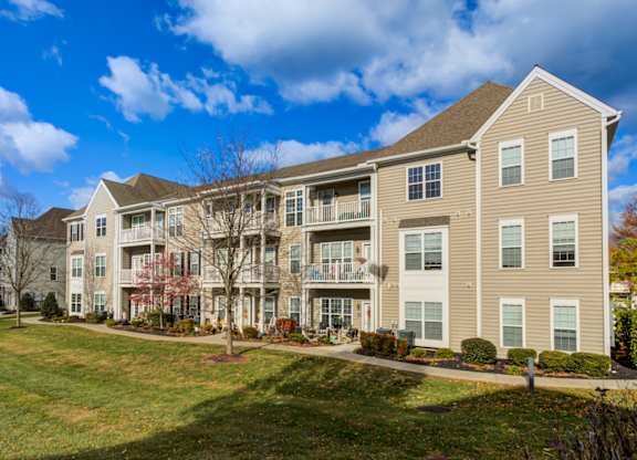 A large apartment complex with a grassy front yard at Meridian West Shore, Mechanicsburg, PA 17055