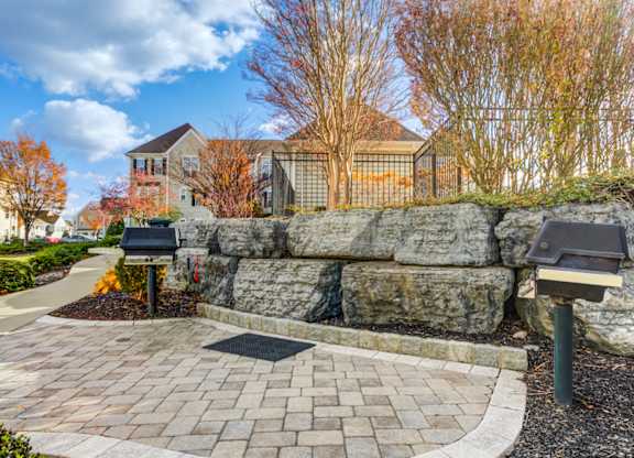 A house with a stone wall and a brick walkway in front at Meridian West Shore, Mechanicsburg, PA 17055