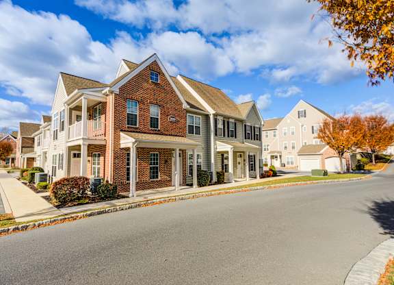A row of houses with a tree in the foreground at Meridian West Shore, Pennsylvania