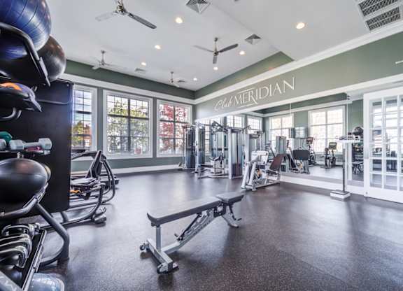 A gym with a variety of equipment including a rowing machine at Meridian West Shore, Mechanicsburg, PA