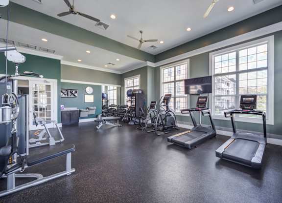 A spacious gym with treadmills, weights, and exercise equipment at Meridian West Shore, Mechanicsburg, PA 17055