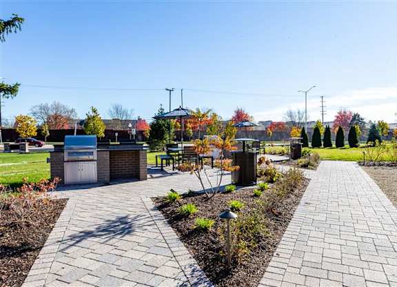 Landscaped outdoor barbecue area at fifty9 Grove Apartments, Illinois, 60563
