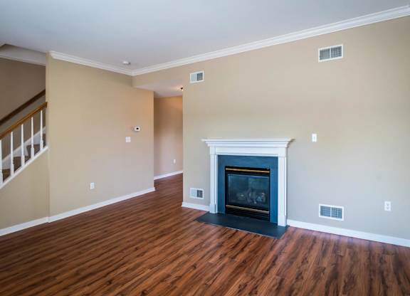 A living room with a fireplace and wood flooring at Highlands at Warwick Apartments, Lilitz, 17543
