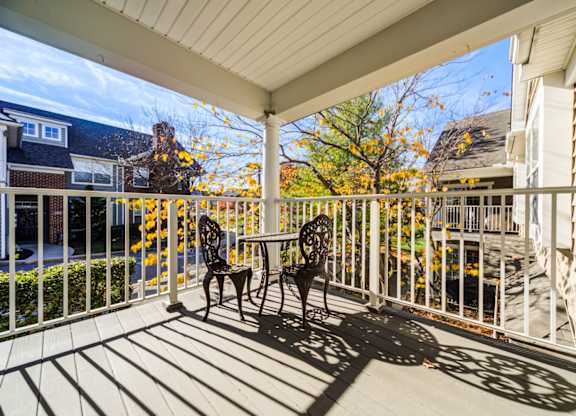 A patio with a table and chairs is covered by a roof at The Crest at Elm Tree, Pennsylvania 17552