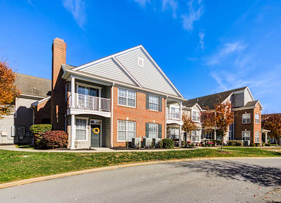A row of townhouses with a clear blue sky above them at The Crest at Elm Tree, Mount Joy