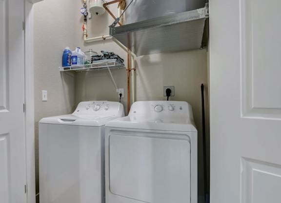 In unit washer and dryer with storage shelves at Reserve at Romeoville, Romeoville, IL