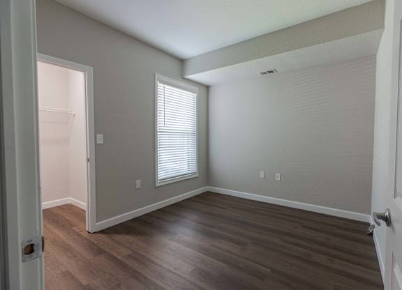 Empty room with wooden floor at Woodland Meadows, Clinton Township, MI, 48035
