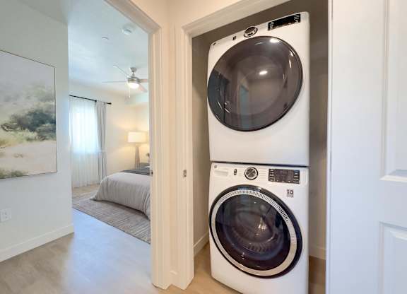Liberty Sage Apartments, Park City, Utah, a white front load washing machine and dryer in a closet-like space.