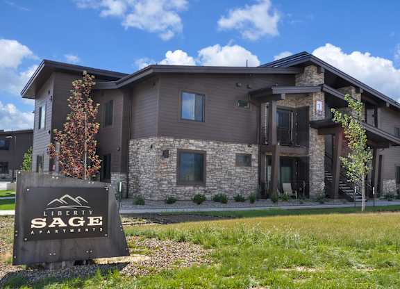 A modern house with a sign that says "Liberty Sage" in front of it.