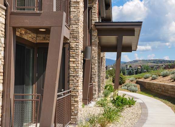 A modern house with a curved walkway in front.