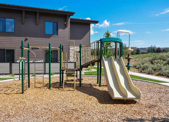 A playground with a slide, swings, and a climbing frame.