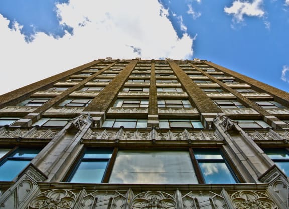 an upward view of a tall building with a cloudy sky at Garment Lofts, California, 90014