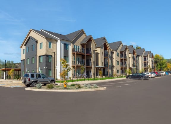 an empty parking lot in front of an apartment building