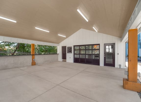 the inside of a building with a concrete floor and a door