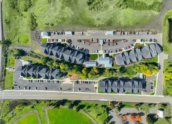 a birds eye view of a parking lot with cars and buildings