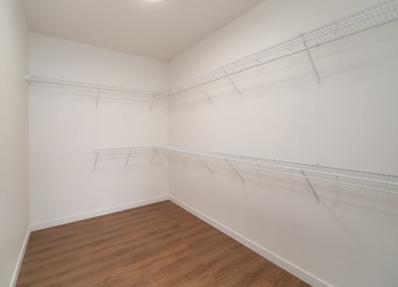 an empty room with white walls and a wood floor