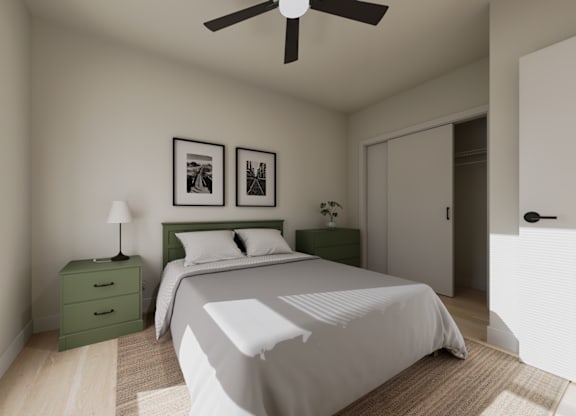 A bedroom with a bed, nightstand, and two pictures on the wall.