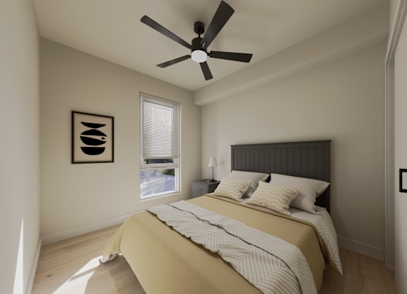 A bedroom with a bed, a ceiling fan, and a window.