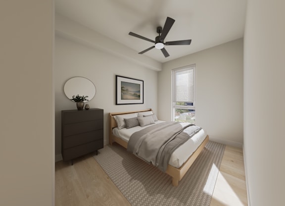 A bedroom with a bed, dresser, and a ceiling fan.