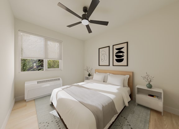 A bedroom with a bed, nightstand, and window.