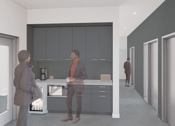 A man and woman are standing in a modern kitchen.