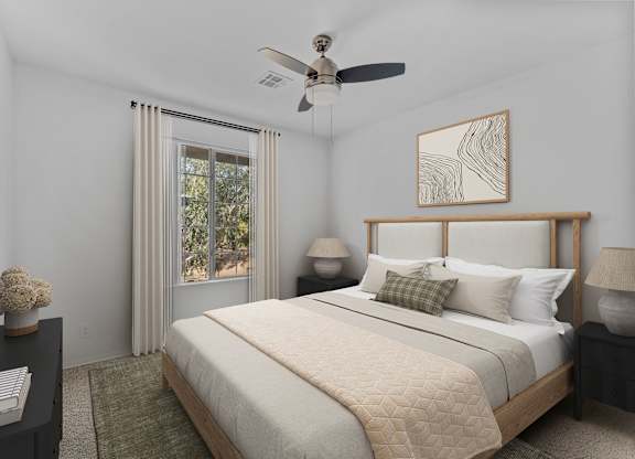 A bedroom with a large bed, a ceiling fan, and a window with curtains.